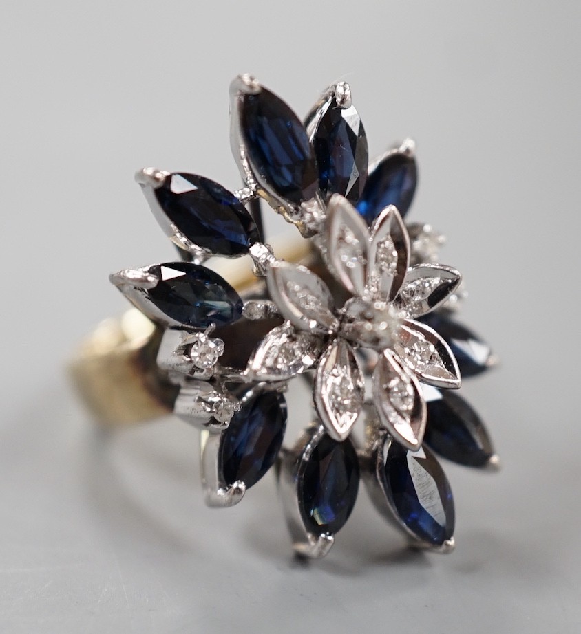 A modern 18k, sapphire and illusion set diamond chip set cluster dress ring, size K, gross weight 8.1 grams.